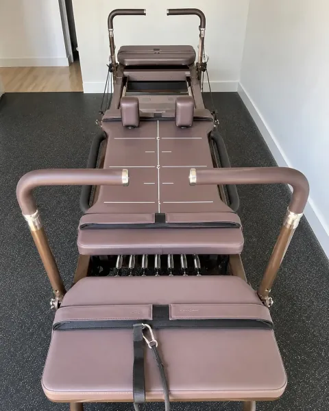 Full-length brown-upholstered Carriage One viewed from above in a studio room